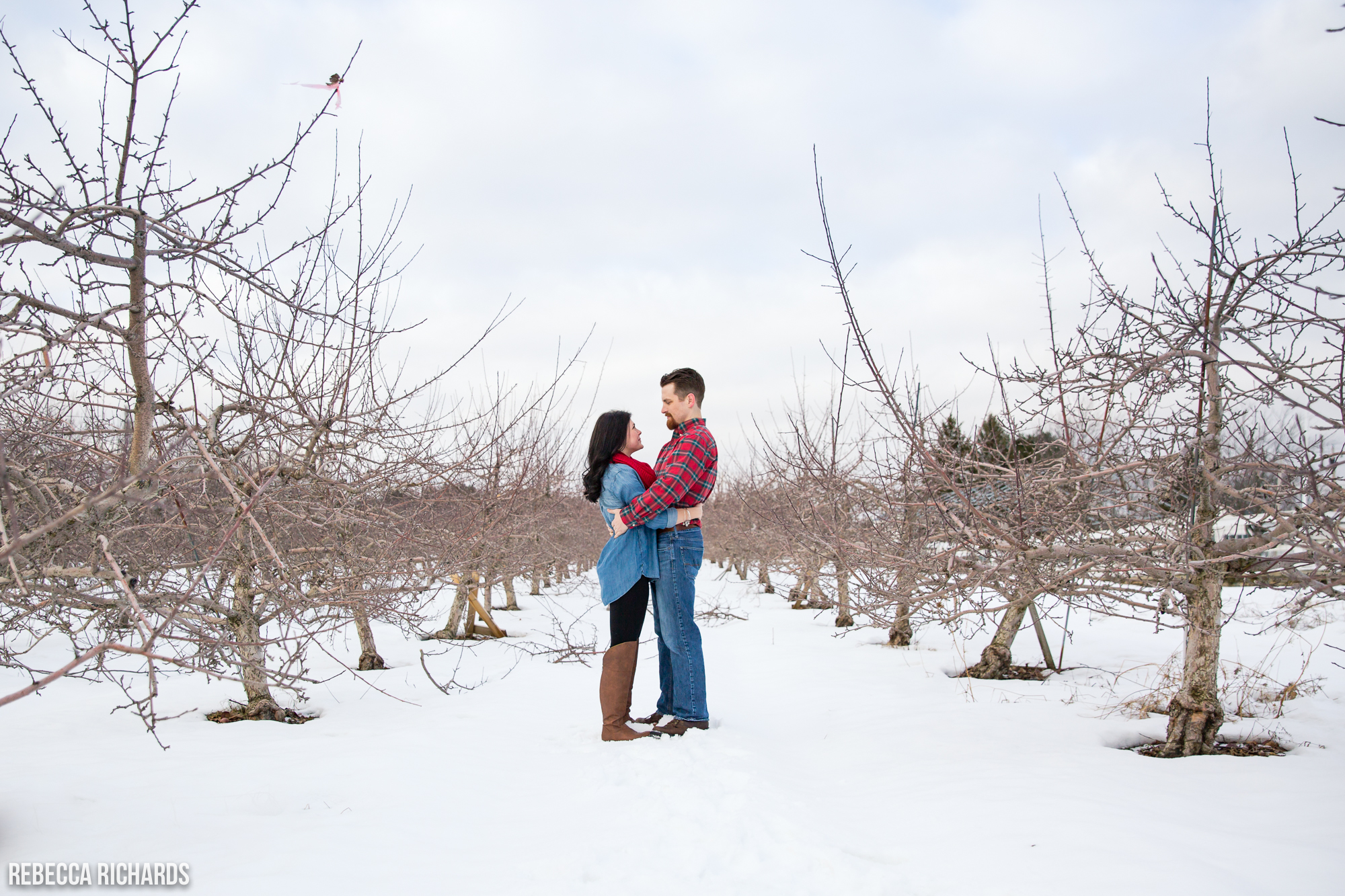 Maine winter engagement photography in apple orchard