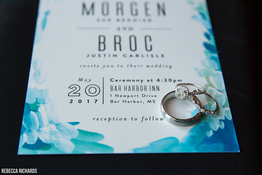 Shot of rings with wedding invitation