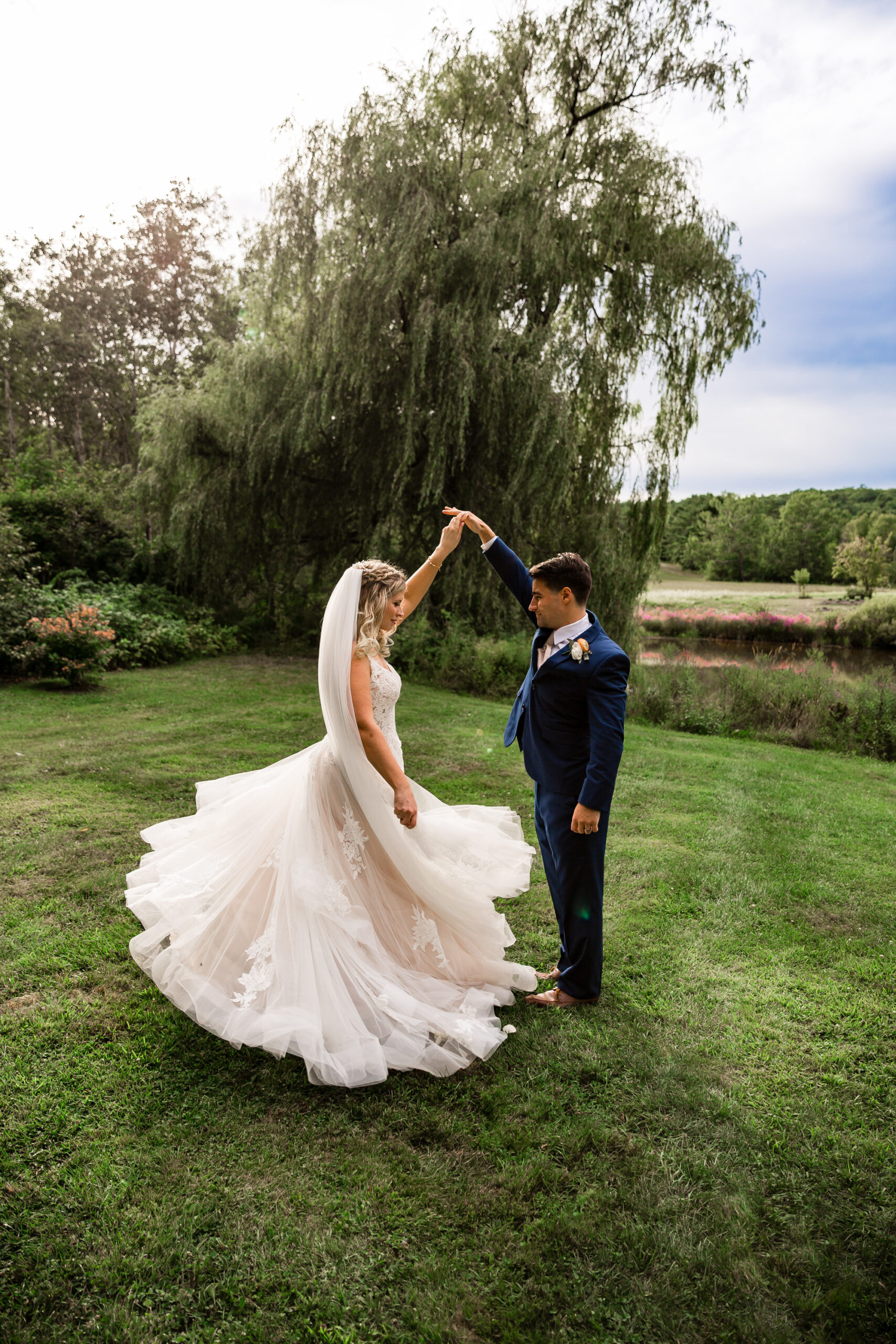 Bride twirling at an outdoor wedding in Maine